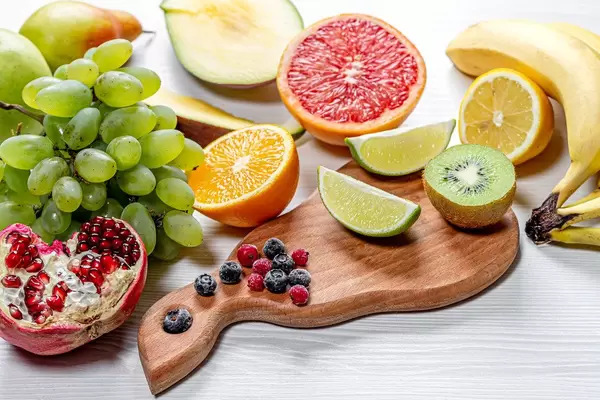 Fresh ripe fruits and berries on white wooden background (Flip 2019)