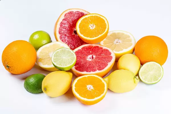 Fresh ripe lemons, oranges, grapefruits and limes on a white background