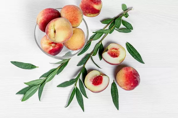 Fresh ripe peaches with leaves. Top view