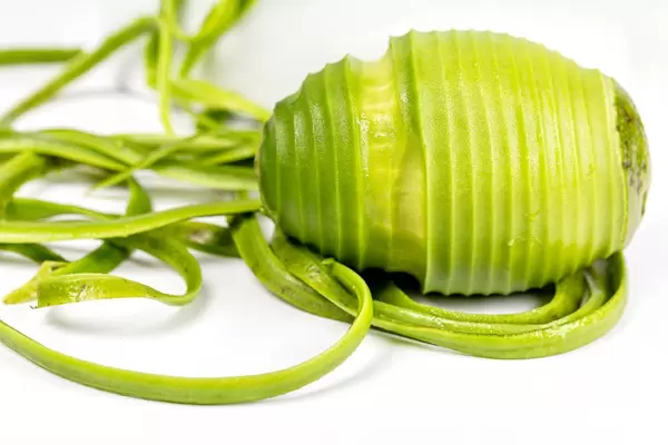 Fresh ripe peeled avocache with long peelings