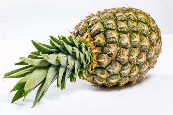 Fresh ripe whole pineapple on white background