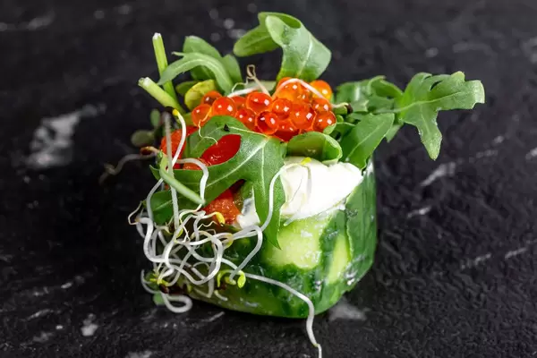 Fresh roll with cucumber, salmon, California cheese, arugula, micro greens and red caviar