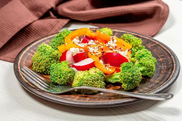 Fresh salad of broccoli, radish, bell pepper and flax seeds, sesame seeds, poppy seeds (Flip 2019)