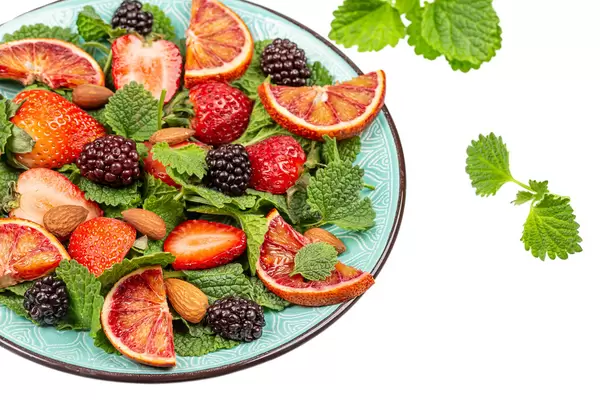 Fresh salad with fruits and almonds, close up
