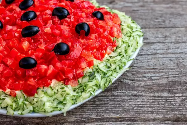 Fresh salad with tomatoes, cucumbers and black olives close-up (Flip 2019)