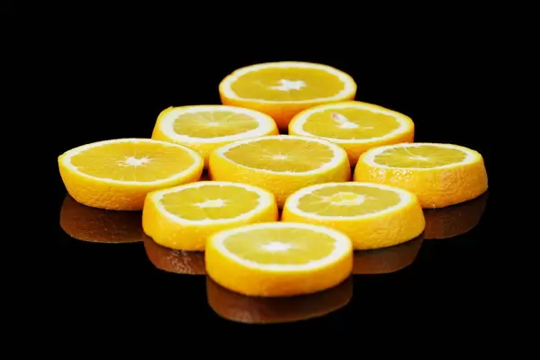 Fresh slices of orange fruit, black background