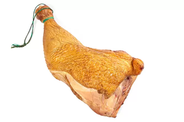 Fresh smoked chicken leg on white
