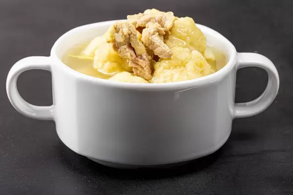 Fresh soup in a white tureen on a black background (Flip 2020)