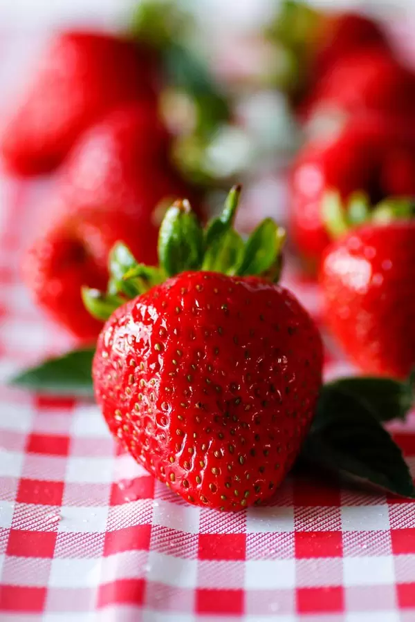 fresh stawberries on a white and red background