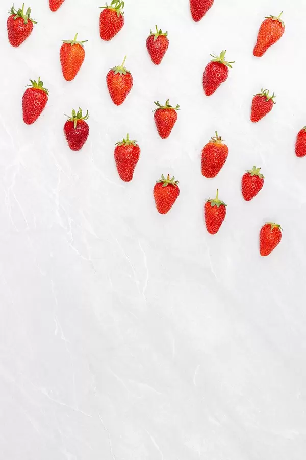 Fresh Strawberries falling from the sky as rockets with copy space