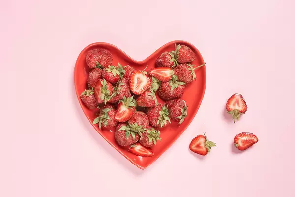 Fresh strawberry fruits on a heart-shaped plate
