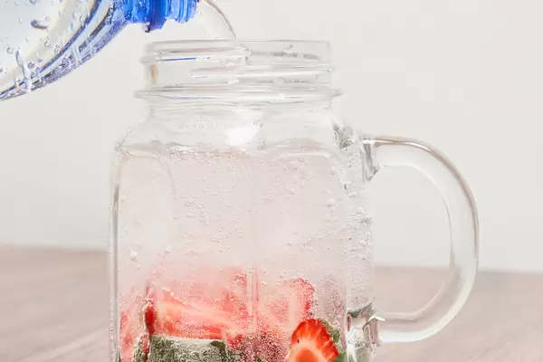 Fresh summer cocktail with strawberry and ice cubes