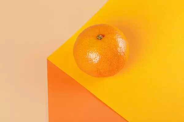 Fresh tangerine on orange background