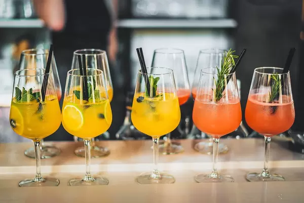 Fresh Tropical Summer Cocktails displayed in a Row on a Bar Table