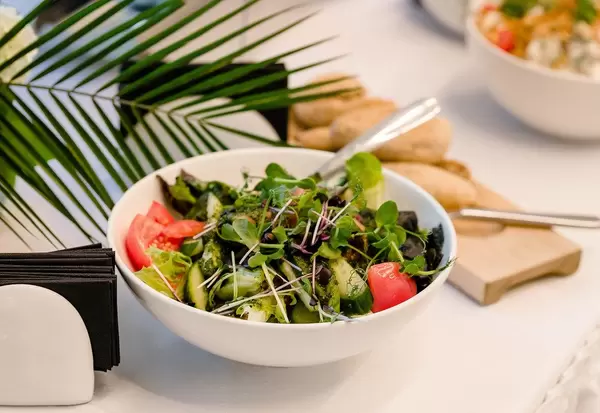 Fresh Vegetable Toamtoes Salad Served On The White Table