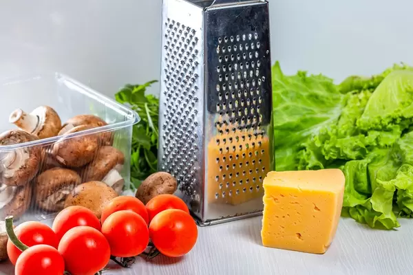 Fresh vegetables and mushrooms with cheese and grater