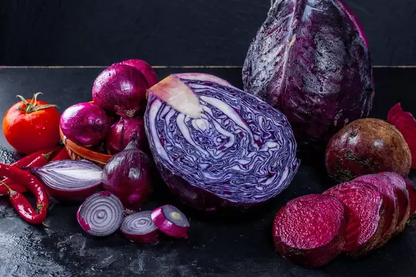 Fresh vegetables with water drops on black background