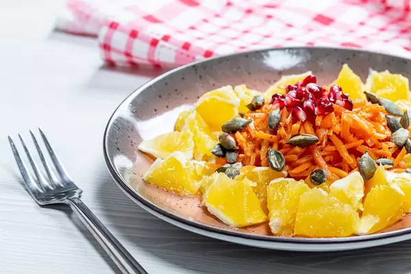 Fresh vegetarian salad with orange and pumpkin seeds