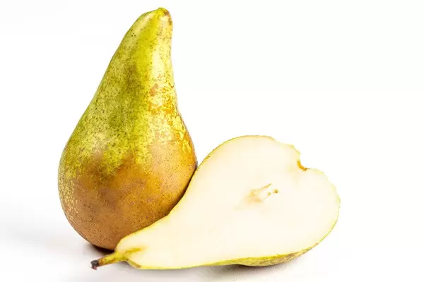 Fresh whole and half pears on a white background