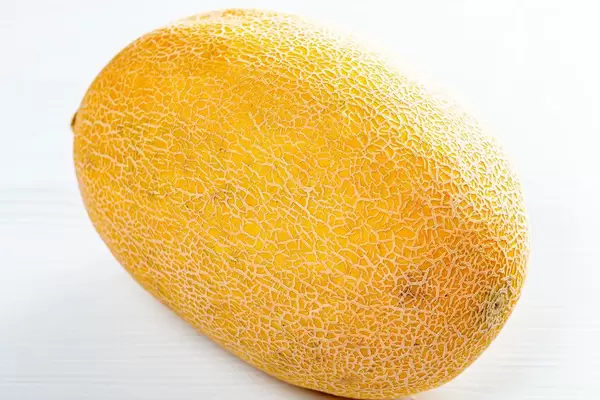 Fresh yellow melon on white wooden table (Flip 2019)