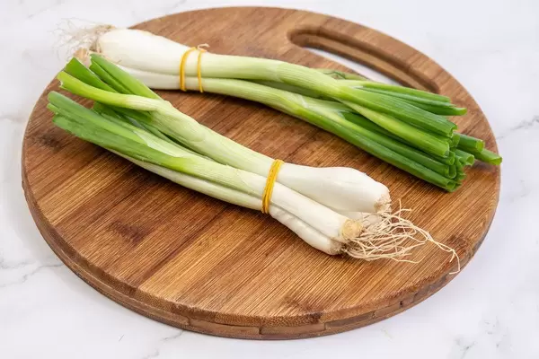 Fresh young Onion on the wooden board