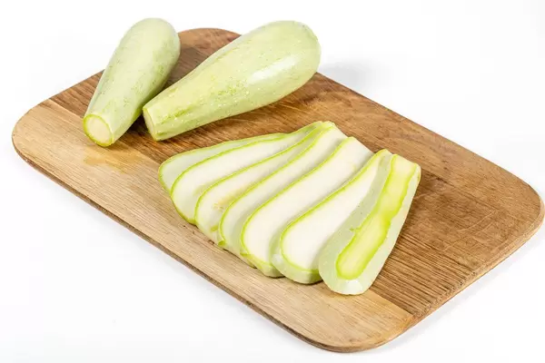 Fresh zucchini on a wooden kitchen board