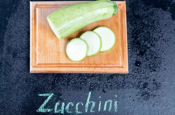 Fresh zucchini on the kitchen Board with the inscription