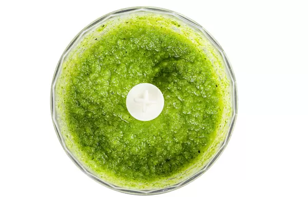 Freshly cooked green smoothie in a blender, top view