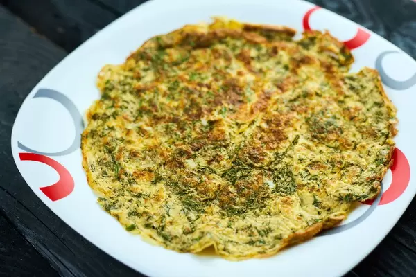 Freshly cooked homemade omelet with herbs