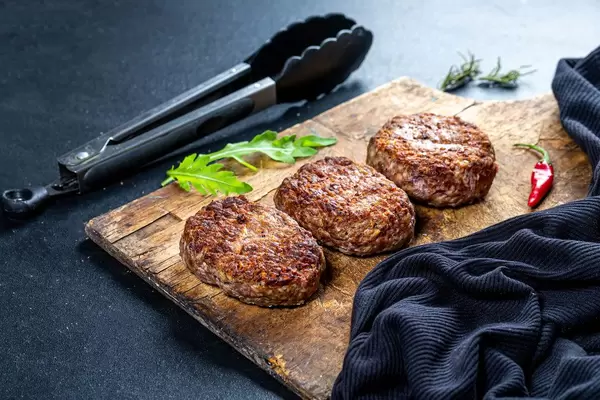 Freshly grilled burger meat on black background (Flip 2019)