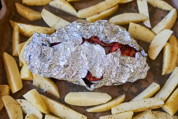 Freshly grilled potatoes and meat in falg