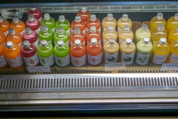 Freshly Squeezed Fruit Juices, Milk Coffee, Milk Tea and Kombucha in Glass Bottles in a Display Fridge