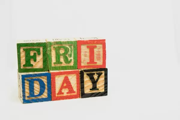 Friday text formed from wooden blocks on white background