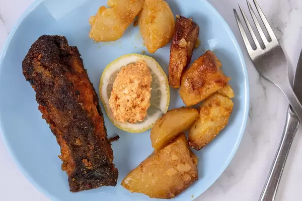 Fried Carp fish served with Potatoes and Salad on the plate (Flip 2019)