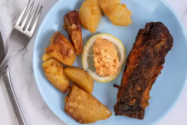 Fried Carp fish served with Potatoes and Salad on the plate