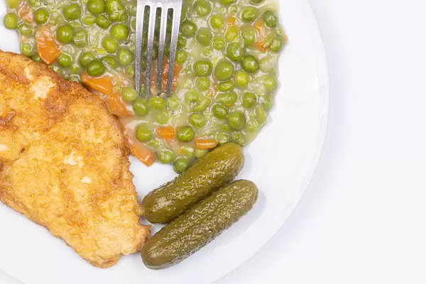 Fried Chicken breasts with cooked Green Peas