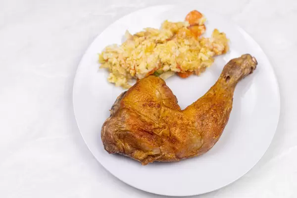 Fried chicken Drumstic served with Risotto on the plate