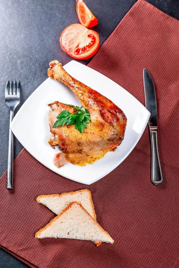 Fried chicken leg with Cutlery and brown dish towel