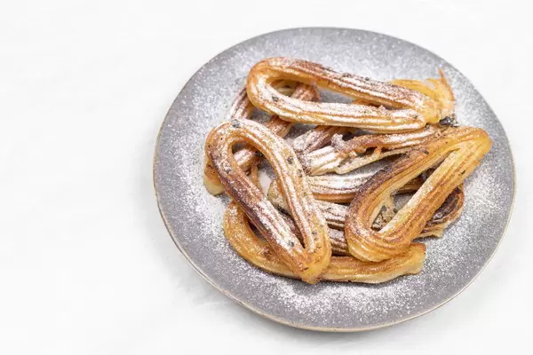 Fried Churros served with powdered sugar