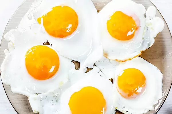 Fried eggs on a glass plate