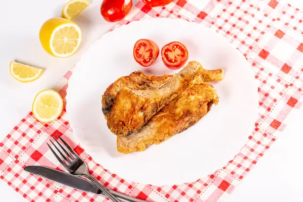 Fried fish carp with tomatoes and lemon