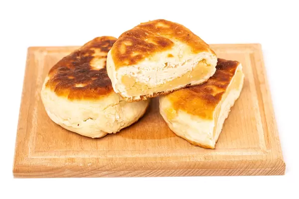 Fried pies with peas on a wooden board