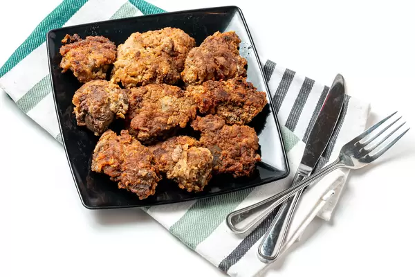 Fried pork liver with fork and knife