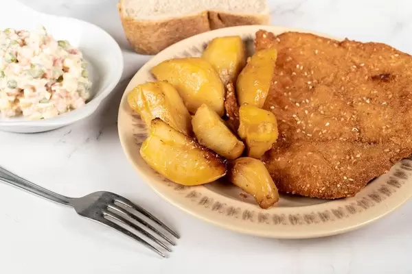 Fried Pork Meat with baked Potatoes and Vegetable salad