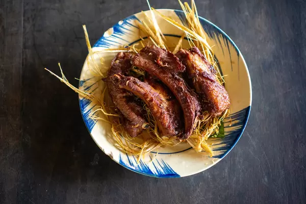 Fried Pork Ribs on Fried Lemongrass on a Wooden Table in a Vietnamese Restaurant