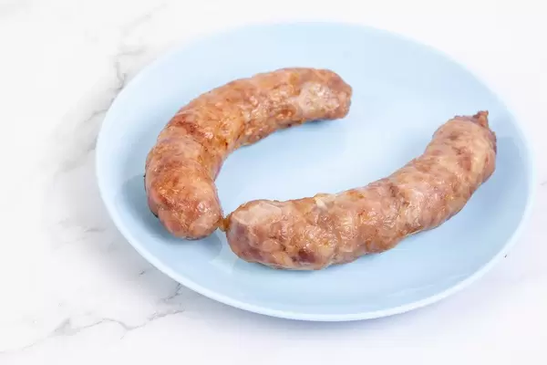 Fried Pork Sausages served on the blue plate