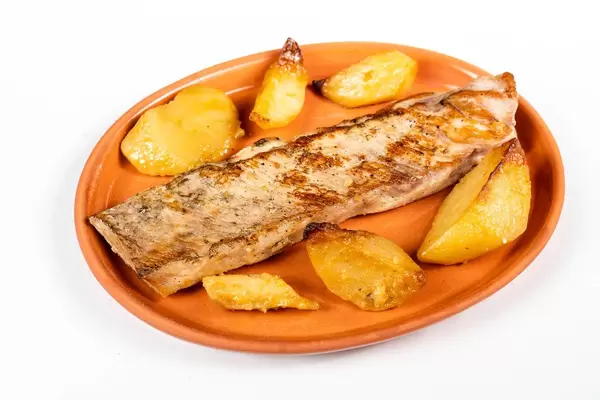 Fried Pork Steak and Potatoes isolated on a clay plate
