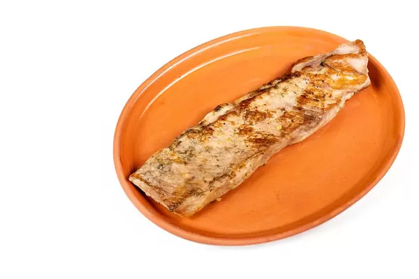 Fried Pork Steak isolated on a clay plate