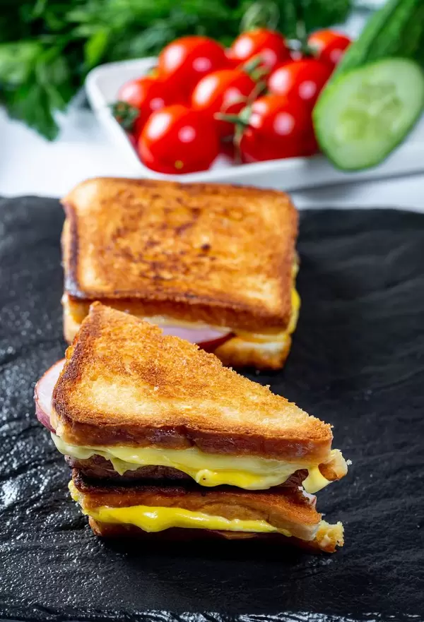 Fried toast whole and half on a black stone tray