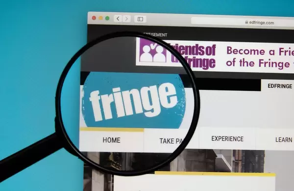 Fringe Festival logo on a computer screen with a magnifying glass
